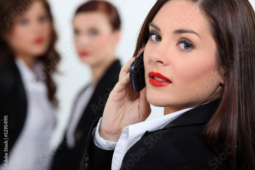 Photo: Businesswoman in red lipstick using a cellphone Businesswoman in red lipstick using a cellphone