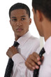 Young businessman adjusting tie before interview