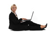Photo: A businesswoman sitting on the floor with her laptop. A businesswoman sitting on the floor with her laptop.
