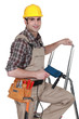 Photo: Laborer with drill on a ladder Laborer with drill on a ladder