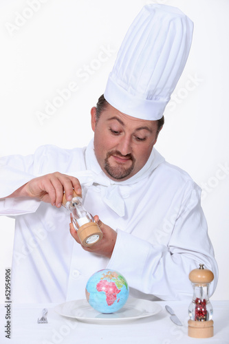 Photo: Chef putting salt on his meal Chef putting salt on his meal