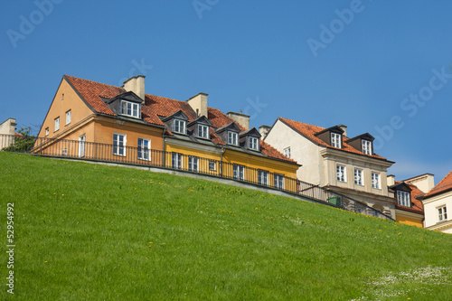 Photo: colorful houses of warsaw old town over green hill colorful houses of warsaw old town over green hill