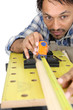 Photo: Carpenter measuring a piece of wood Carpenter measuring a piece of wood