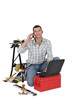 Photo: Carpenter using the internet to order parts Carpenter using the internet to order parts