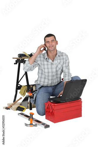 Photo: Carpenter using the internet to order parts Carpenter using the internet to order parts