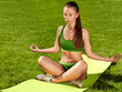 A beautiful sporty woman  doing stretching exercise against natu
