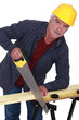 Photo: Artisan sawing wood Artisan sawing wood
