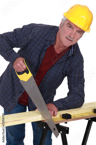 Photo: Artisan sawing wood Artisan sawing wood