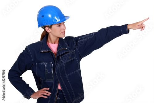 Photo: A female manual worker pointing at something. A female manual worker pointing at something.