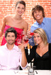 Photo: Two young couples drinking wine in restaurant Two young couples drinking wine in restaurant