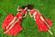 Two young women lying on grass