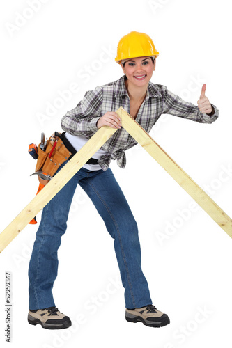 Photo: A female carpenter giving the thumb up. A female carpenter giving the thumb up.