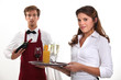 Wine waiter and waitress, studio shot