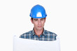 Photo: A foreman checking plans. A foreman checking plans.