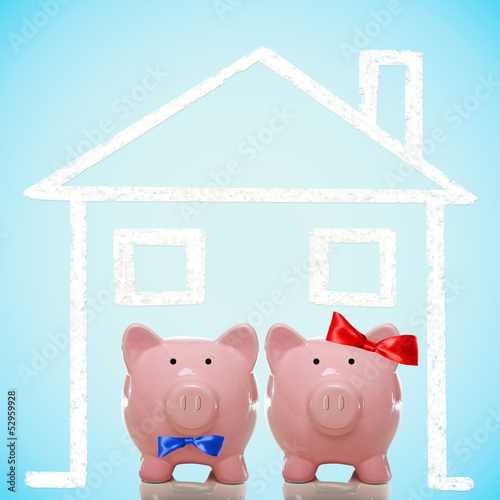 Photo: Piggy bank couple with dream home Piggy bank couple with dream home