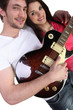 Photo: Young man with a guitar and a pretty girl Young man with a guitar and a pretty girl