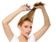 Photo: Unhappy woman cutting her hair with scissors Unhappy woman cutting her hair with scissors