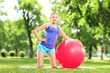 Young female in sportswear resting in park
