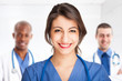 Smiling nurse in front of her team