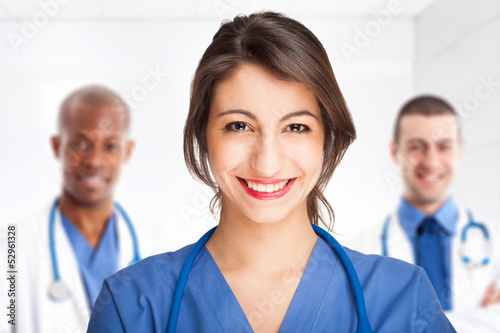Photo: Smiling nurse in front of her team Smiling nurse in front of her team
