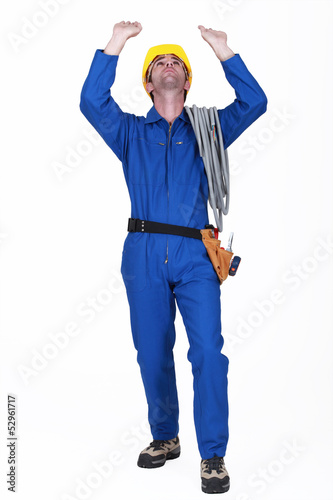 Photo: A construction worker raising his hands. A construction worker raising his hands.