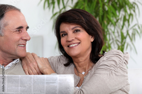Photo: Senior couple reading the newspaper Senior couple reading the newspaper