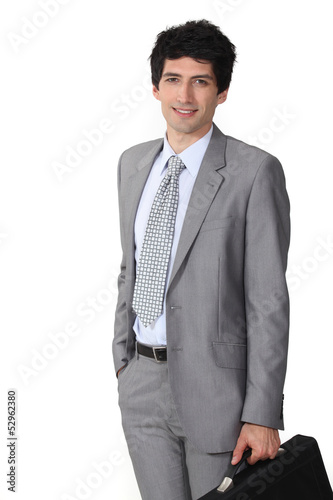 Photo: Driven young businessman with briefcase Driven young businessman with briefcase