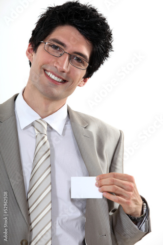 Photo: Businessman with glasses showing off business-card Businessman with glasses showing off business-card