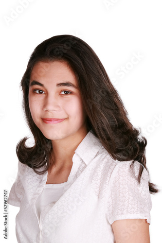 Photo: Beautiful biracial teen girl smiling, confident expression Beautiful biracial teen girl smiling, confident expression