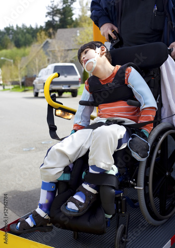 Photo: Disabled boy on school bus wheelchair lift Disabled boy on school bus wheelchair lift
