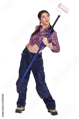 Photo: Sexy woman holding a paint roller Sexy woman holding a paint roller