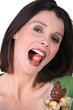 Photo: a woman with an Easter egg in the mouth a woman with an Easter egg in the mouth