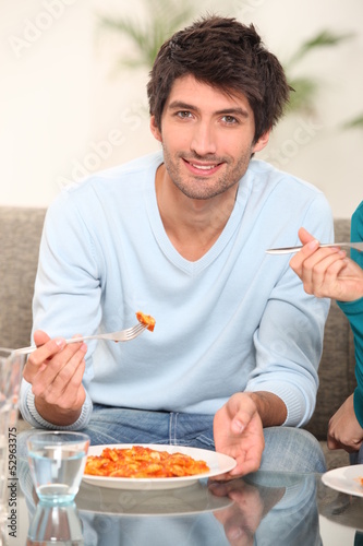 Photo: Young woman eating pasta Young woman eating pasta