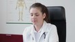 Female doctor working on a laptop in the office, tracking shot