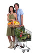 Photo: Couple with a basket and trolley full of fresh produce Couple with a basket and trolley full of fresh produce