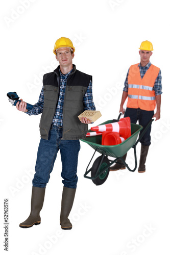 Photo: Two men with masonry equipment Two men with masonry equipment