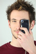 Man covering his eye with a camera