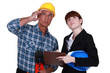 Tradesman and engineer looking at the ceiling