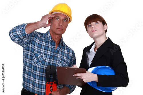 Photo: Tradesman and engineer looking at the ceiling Tradesman and engineer looking at the ceiling