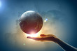 Image of earth planet on hand
