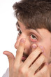 Closeup view of a man's brown eye while inserting a corrective c
