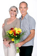 Husband giving wife flowers