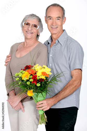Photo: Husband giving wife flowers Husband giving wife flowers