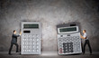 Businesspeople with big calculators