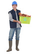 Photo: Builder stood with box of recyclable material Builder stood with box of recyclable material