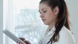 Portrait of female doctor with tablet computer in her office
