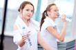 Women drinking water after sports