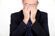 Businessman rubbing his eyes