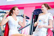 Woman doing splits on machine with weights
