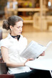 Serious business woman reading newspaper